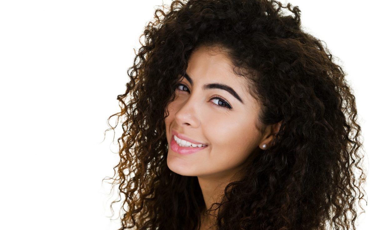 woman with hair curls smiling